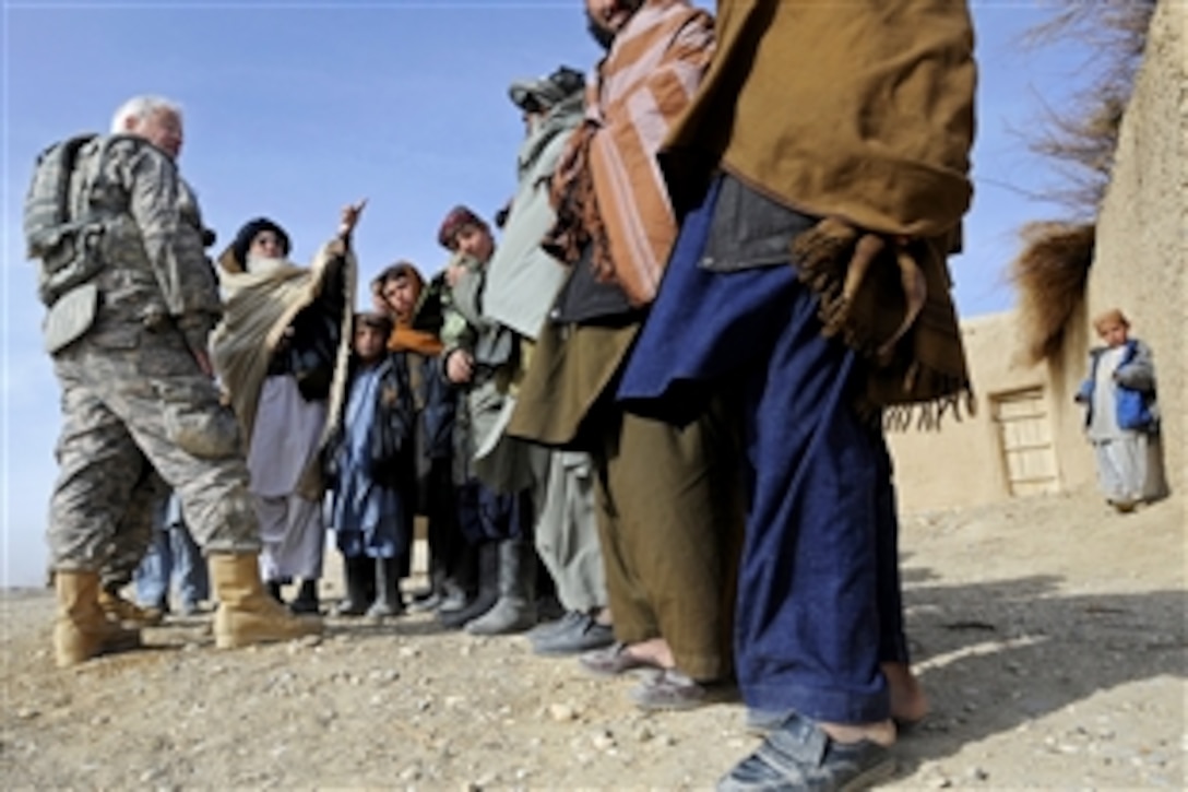 U.S. Army Chief Warrant Officer Ronald Brooks, left, talks with residents about the site of a well in the Khwazi village, Afghanistan, Dec. 14, 2010. Brooks, assigned to Provincial Reconstruction Team Zabul, visited the village to survey a site for a future well project.