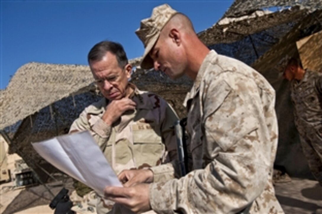 U.S. Navy Adm. Mike Mullen, chairman of the Joint Chiefs of Staff, looks at the area of operations with U.S. Marine Corps Lt. Col. Kyle Ellison during a visit to Camp Hanson in Afghanistan's Helmand province, Dec.16, 2010. Ellison is the commanding officer for the 2nd Ballalion, 6th Marine Regiment.  Mullen and his wife, Deborah, are hosting a USO holiday tour in the country.