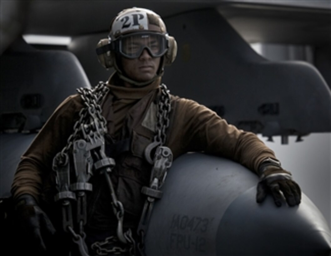 Airman Amir Lindsay, a plane captain assigned to Strike Fighter Squadron 81, waits for the next recovery cycle on the flight deck of the aircraft carrier USS Carl Vinson (CVN 70) underway in the Pacific Ocean on Dec. 15, 2010.  The Carl Vinson and Carrier Air Wing 17 are conducting a three-week composite training unit exercise to be followed by a deployment to the western Pacific Ocean.  