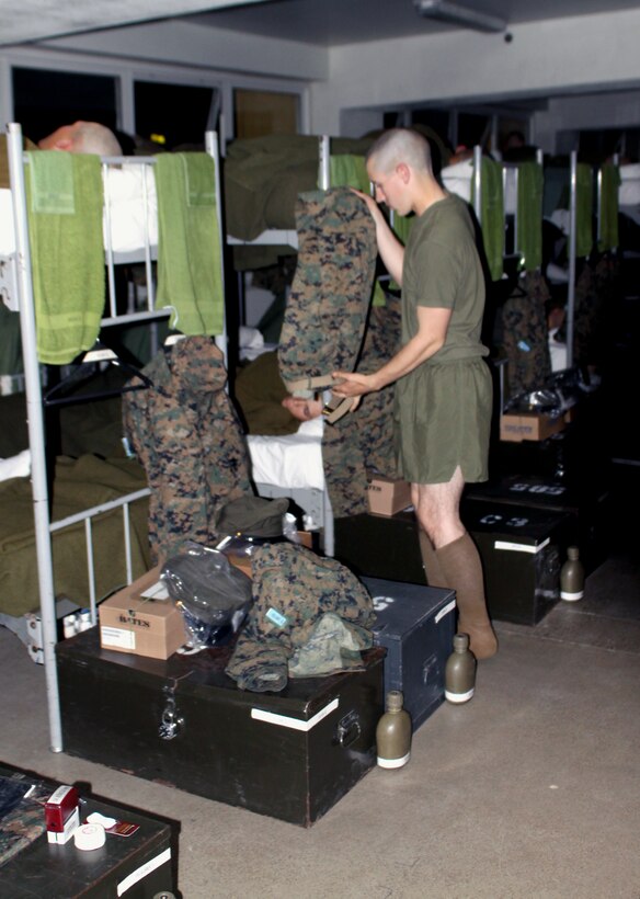 Recruit Gerald Holman, Platoon 3251, Company L, quickly dresses for his upcoming shift on interior guard. The recruits have about 15 minutes to prepare for their upcoming shift.