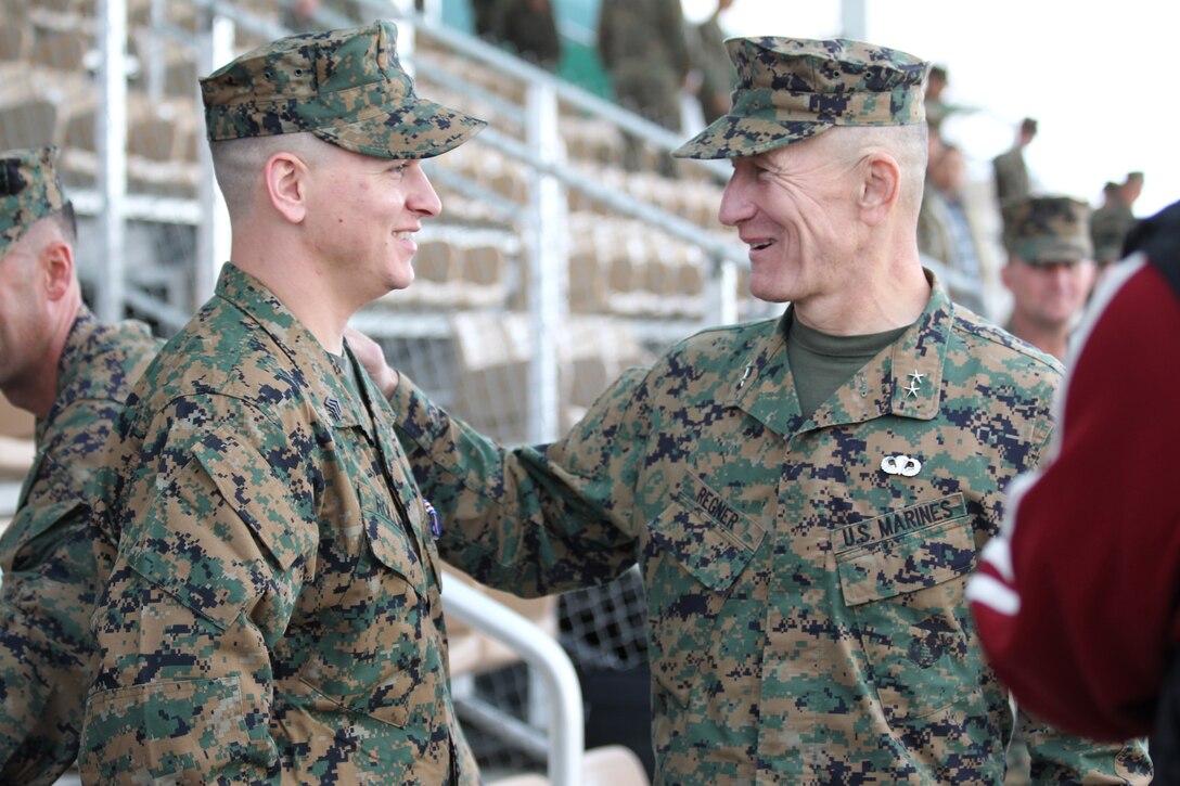 Maj. Gen. Michael R. Regner, commanding general, 1st Marine Division, congratulates Sgt. William W. Rollins during a ceremony in which Rollins was awarded the Silver Star, the Nation's third-highest award during a ceremony at the Combat Center's Lance Cpl. Torrey L. Gray Parade Field Dec. 17, 2010.