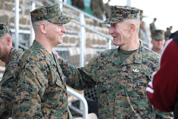 Maj. Gen. Michael R. Regner, commanding general, 1st Marine Division, congratulates Sgt. William W. Rollins during a ceremony in which Rollins was awarded the Silver Star, the Nation's third-highest award during a ceremony at the Combat Center's Lance Cpl. Torrey L. Gray Parade Field Dec. 17, 2010.