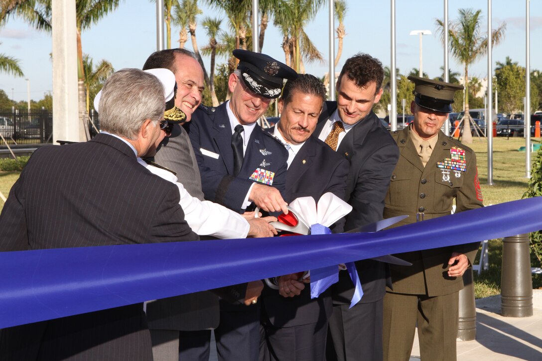 Gen. Douglas Fraser, flanked by military, civic and business leaders representing Miami-Dade county, Doral, Fla., and Hensel-Phelps Construction company, cuts the ribbon opening the new U.S. Southern Command Headquarters.