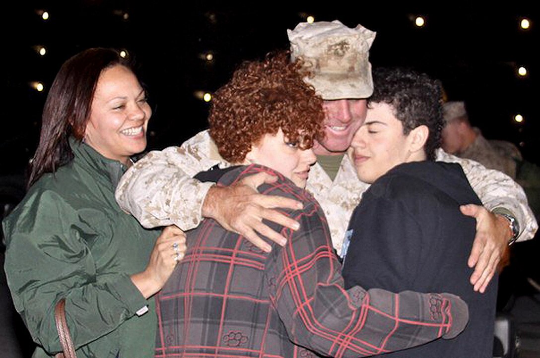 A Marine Corps Systems Command Marine greets his family after returing from a deployment to Afghanistan.