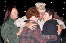 A Marine Corps Systems Command Marine greets his family after returing from a deployment to Afghanistan.
