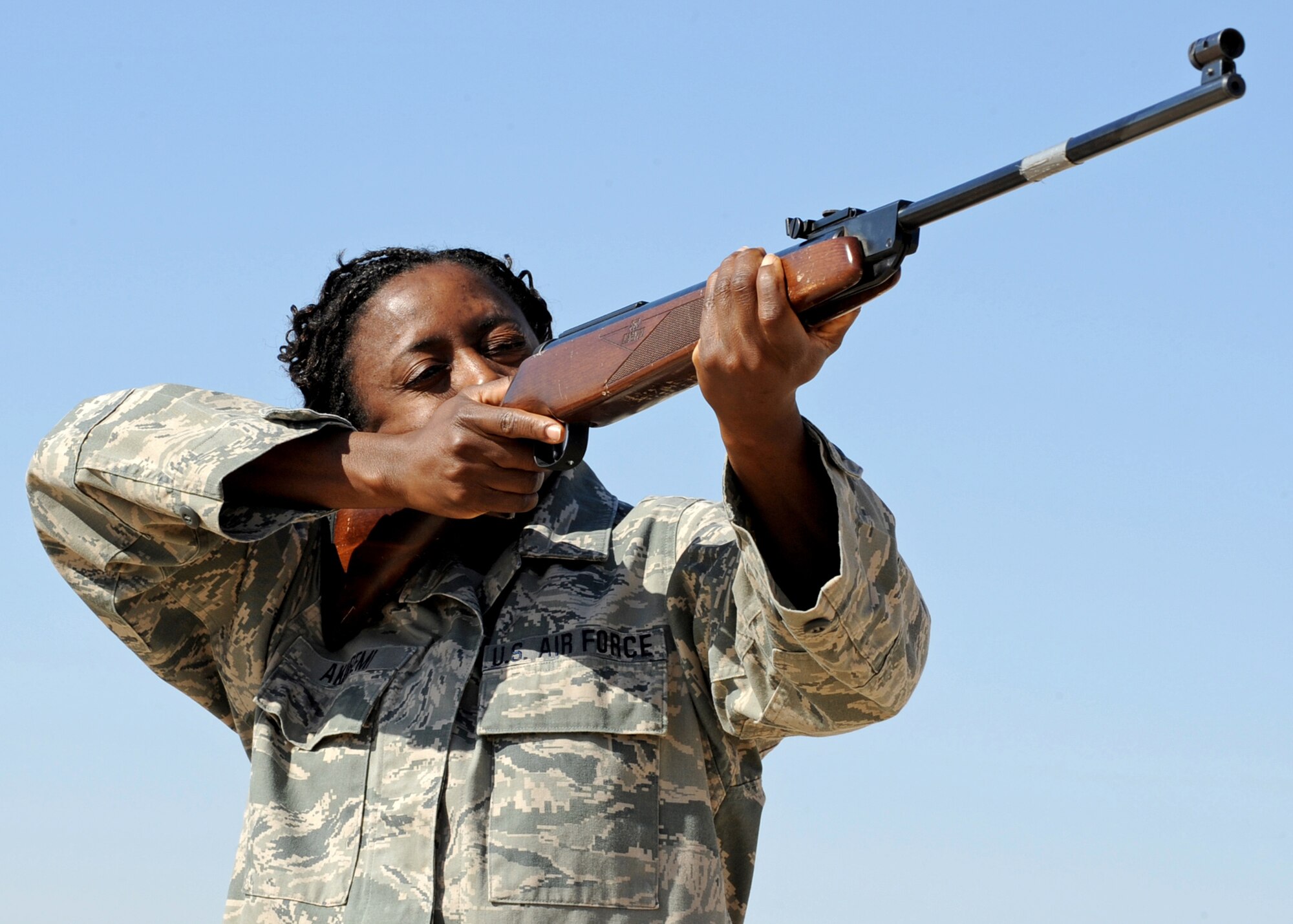 SOUTHWEST ASIA - Staff Sgt. Omolade Akinremi, a pest management specialist with the 386th Expeditionary Civil Engineer Squadron, takes aim at a pigeon at an undisclosed air base Dec. 10, 2010. Airmen from the unit assist with the Bird/Wildlife Aircraft Strike Hazard, or BASH, program, which helps reduce the number of birds living near the flight line. Bird strikes pose a significant hazard to the flying mission. (U.S. Air Force photo by Senior Airman Laura Turner)