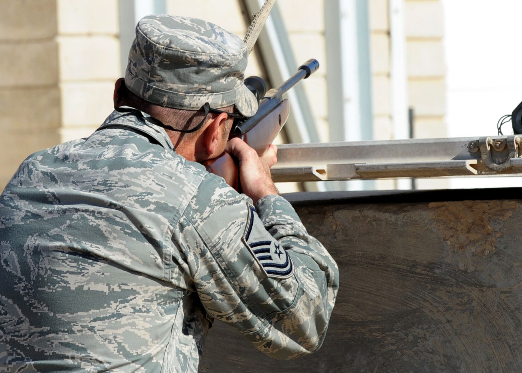 SOUTHWEST ASIA - Master Sgt. Richard Welsh, superintendent of the 386th Expeditionary Civil Engineer Squadron Pest Management Section, points his rifle sights toward an unsuspecting pigeon at an undisclosed base Dec. 10, 2010. Airmen from the unit assist with the Bird/Wildlife Aircraft Strike Hazard, or BASH, program, which helps reduce the number of birds living near the flight line. Bird strikes pose a significant hazard to the flying mission. (U.S. Air Force photo by Senior Airman Laura Turner)