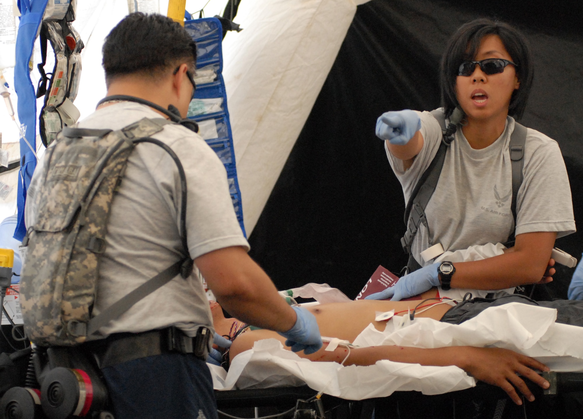 Airmen from the Hawaii Air National Guard's 154th Medical Group stationed at Joint Base Pearl Harbor-Hickam, Hawaii, help the "victim" of a dirty bomb explosion during a week-long Homeland Defense Response validation exercise Dec. 16, 2010, at Bellows Air Force Station, Hawaii. (U.S. Air Force photo/Staff Sgt. Carolyn Viss)