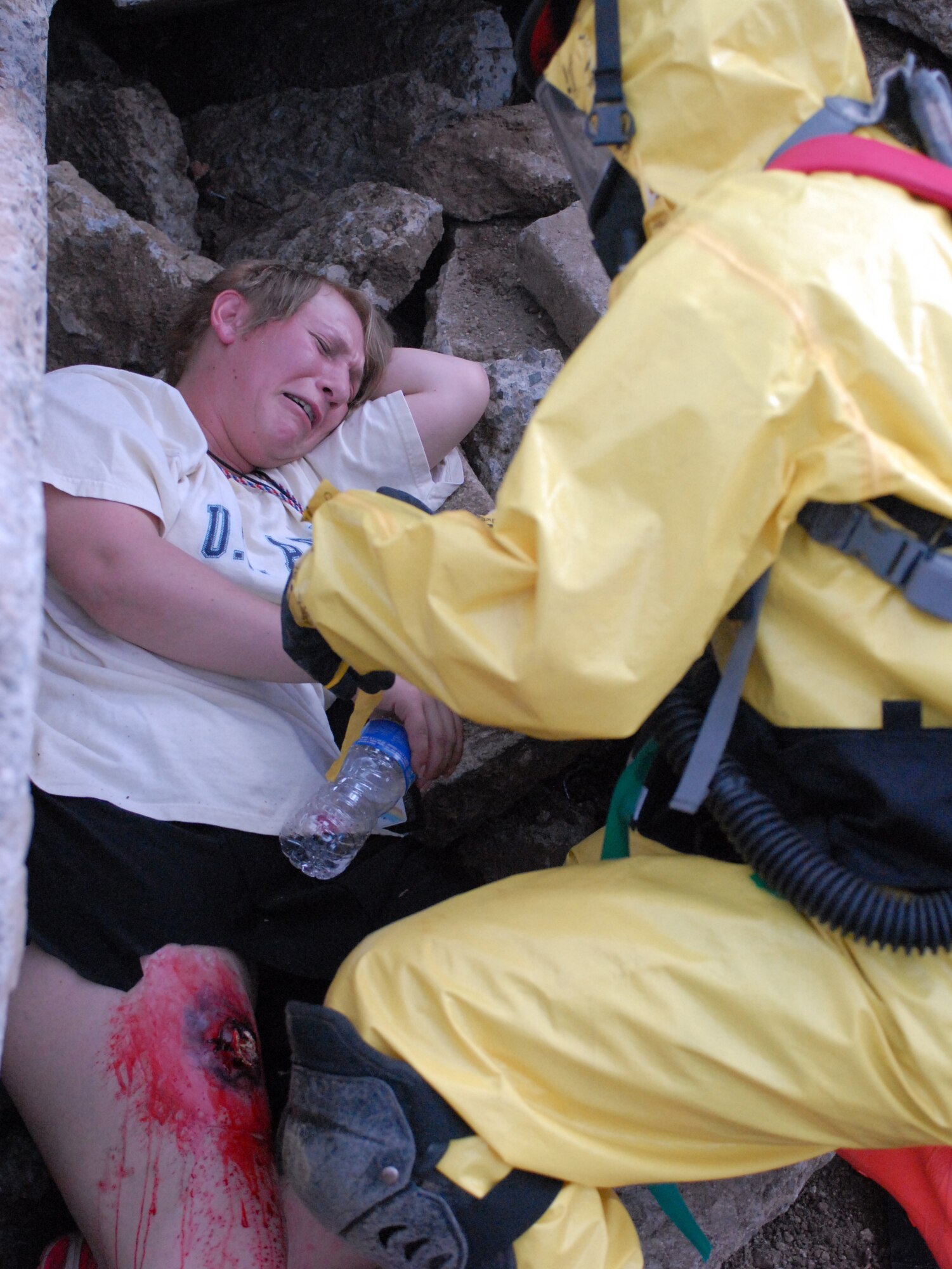Hawaii National Guardsmen dressed in Mission Oriented Protective Posture gear assist "victims" of a dirty bomb explosion during a Homeland Defense Response validation exercise at Bellows Air Force Station, Hawaii, Dec. 16, 2010.  (U.S. Air Force photo/Staff Sgt. Carolyn Viss)