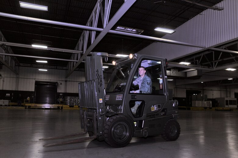 Tech. Sgt. Charles Branum, 62nd Aerial Port Squadron shift supervisor, operates a forklift before securing cargo to pallets Dec. 15 at McChord Field, Joint Base Lewis-McChord, Wash. (U.S. Air Force photo/Adamarie Lewis-Page)
