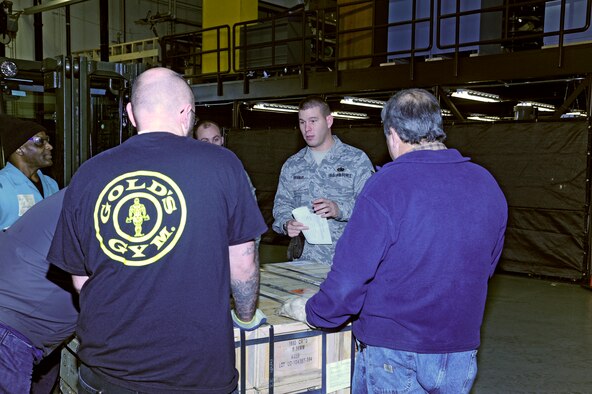 Tech. Sgt. Charles Branum, center, 62nd APS shift supervisor, provides a briefing before moving a large shipment of ammo Dec. 15 at McChord Field, Joint Base Lewis-McChord, Wash. The ammo will be delivered to the Middle East for missions supporting Operation Enduring Freedom. (U.S. Air Force photo/Adamarie Lewis-Page)