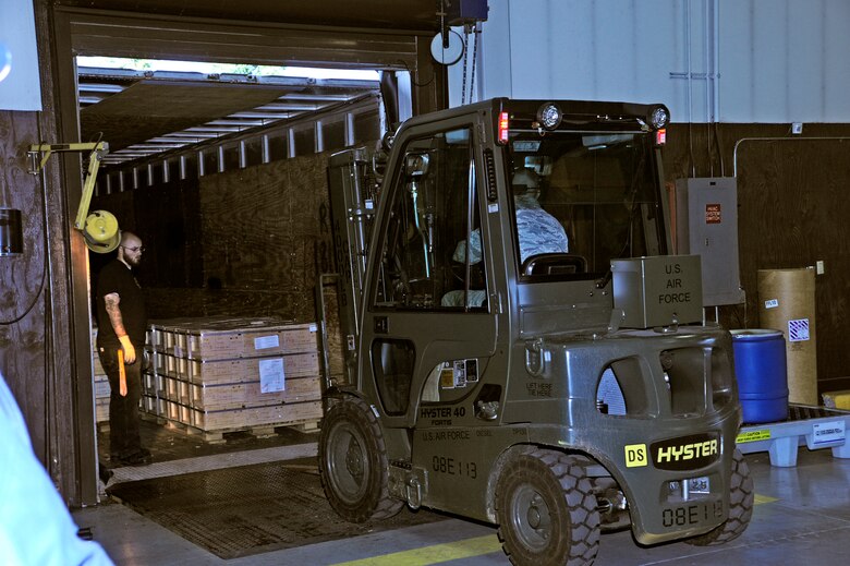 62nd Aerial Port Squadron Airmen and civilians work together to move a shipment of ammo Dec. 15 at McChord Field, Joint Base Lewis-McChord, Wash. (U.S. Air Force photo/Adamarie Lewis-Page)