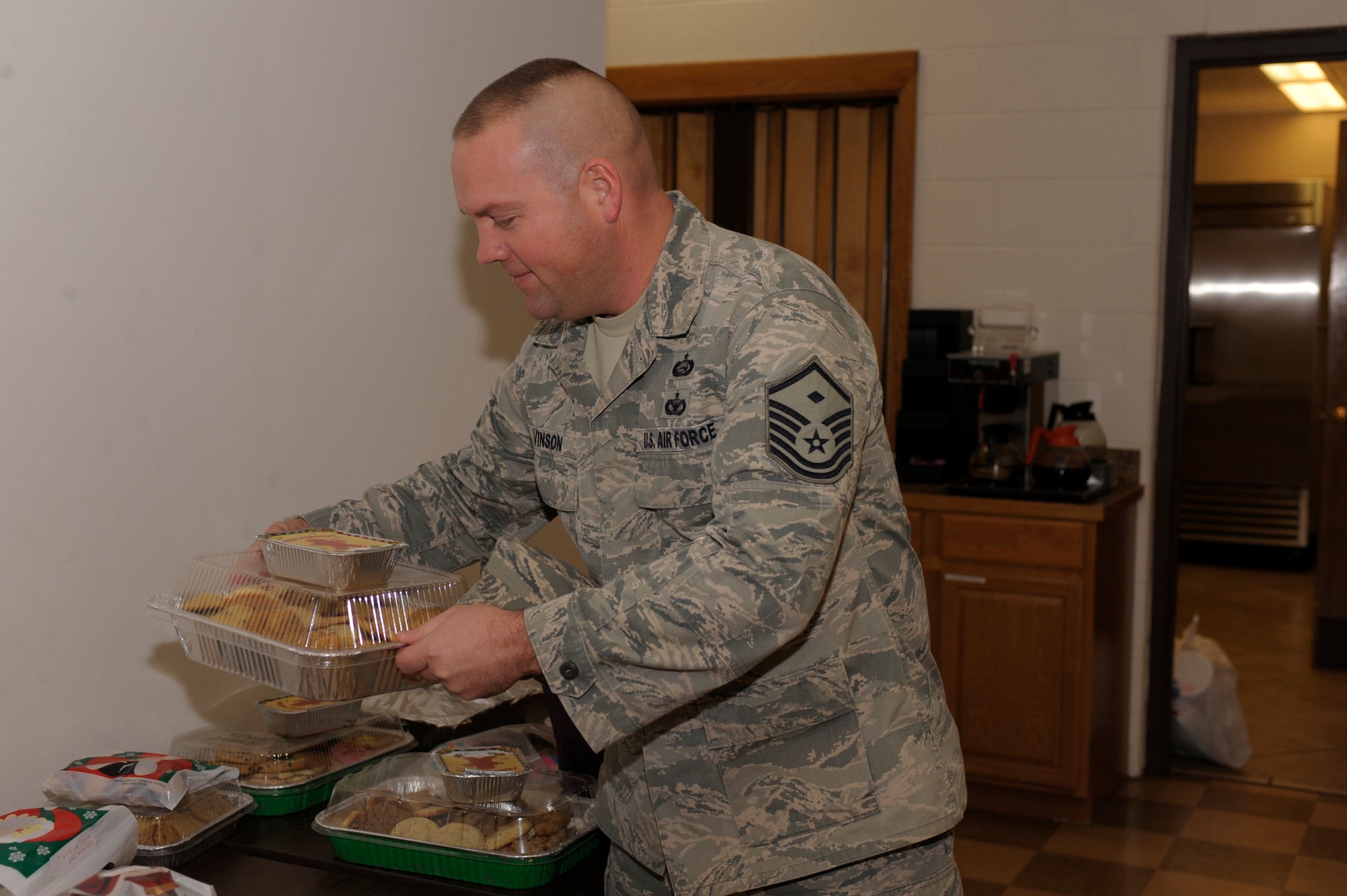 First Sergeant Jason Vinson, 27th Special Operations Equipment Maintenance Squadron, gathers boxes of cookies for his Airmen at the chapel cookie drive Dec. 16. Over 10,000 cookies were donated to the drive and will distributed to the Airmen living in the dorms by their first sergeants. (U.S. Air Force Photo by Airman Ericka Engblom)