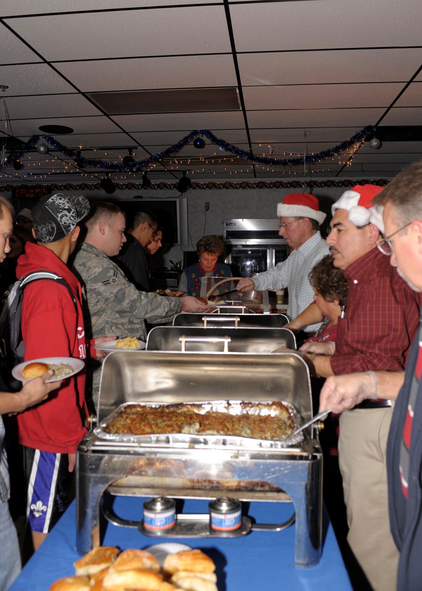 Airman attended a feast prepared for them during the Single Airman's Dinner at the Drop Zone Dec. 14. The evening was filled with free food, fun, dancing and prizes for the over 300 Airmen that attended. (U.S. Air Force Photo by Airman Ericka Engblom)