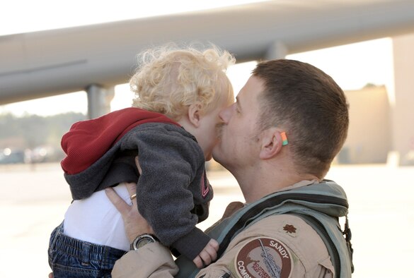 Air Force Week in Photos for Dec. 17, 2010, feature Airmen around the world. In this photo by Airman 1st Class Douglas Ellis, Maj. Dennis Ott kisses his son, Vaughn, after returning to Moody Air Force Base, Ga., Dec. 9, 2010, from his deployment to Afghanistan. Major Ott is a pilot assigned to the 75th Fighter Squadron.
