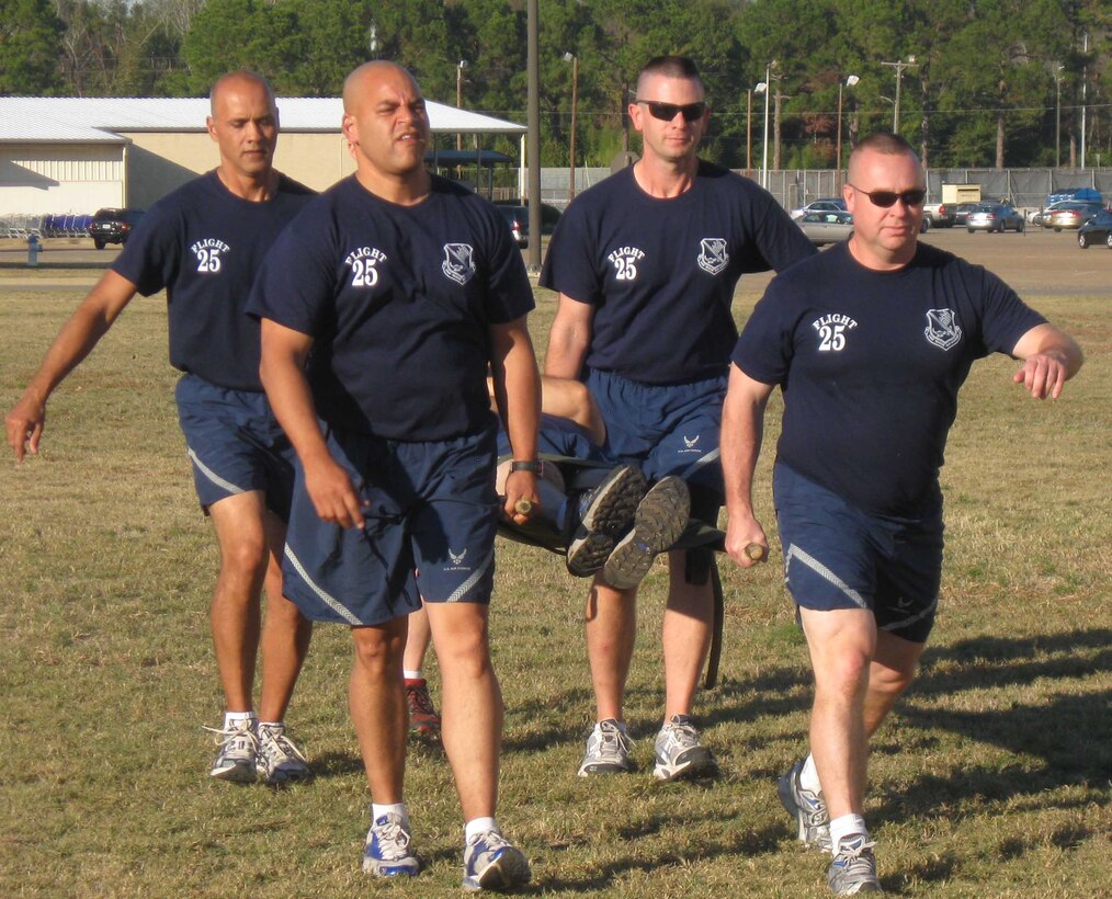 (Clockwise from Left) Senior Noncommissioned Officer Academy students Senior Master Sgt. Geraldo Moore, Master Sgt. Jeff Wilson, Senior Master Sgt. Thomas Fredrickson and Master Sgt. Jay Perez compete in a timed litter-carry event during Warrior Challenge at the Senior NCO Academy course at Gunter Annex, Ala. Students were required to carry a litter through a coned course as many times as they could in 10 minutes.  Other Warrior Challenge events included unexploded ordnance identification, a warrior relay and a fitness event featuring pull ups, sit ups and a timed run. (Air Force photo by Senior Master Sgt. Eugene Miller)