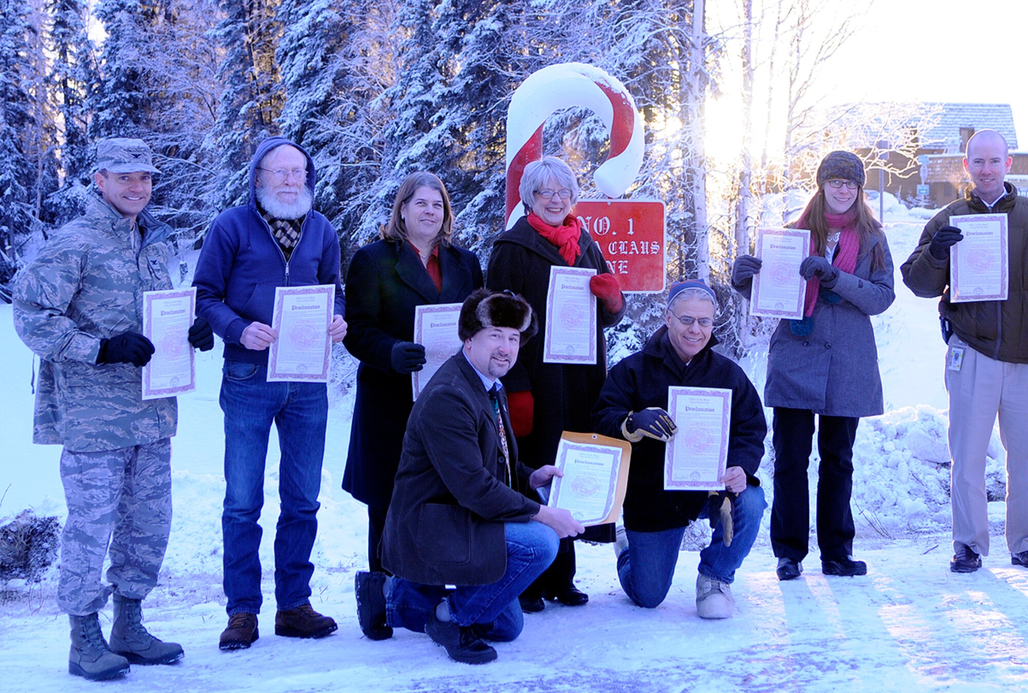 Col. Lynn Scheel joins North Pole, Alaska, community leaders Dec. 3, 2010, for a formal ceremony designating a permanent candy-cane marker as Santa's new address. By keeping the Letters to Santa program alive, North Pole volunteers can continue to recognize the efforts of the originators of the program at Eielson Air Force Base, Alaska. Colonel Scheel is the vice wing commander of the 354th Fighter Wing at Eielson AFB. (U.S. Air Force photo/Airman 1st Class Yash Rojas)