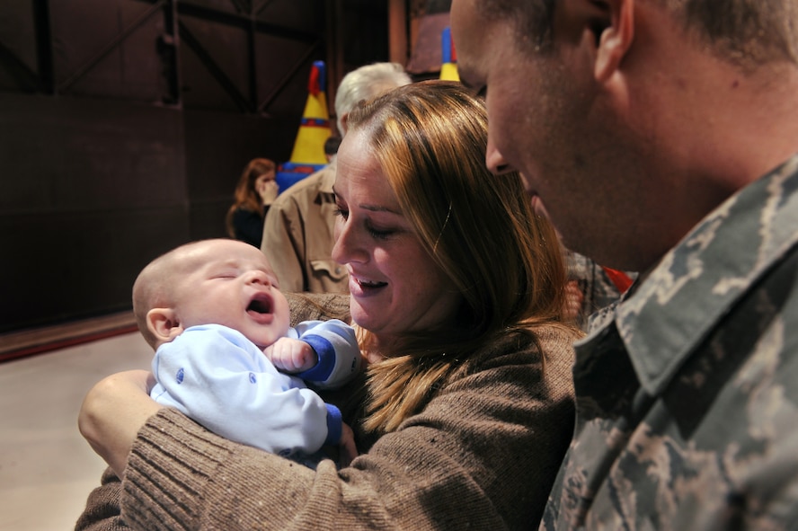 MOODY AIR FORCE BASE, Ga.-- Christie Herdson shows her husband, Staff Sgt. Joshua Herdson, 23rd Aircraft Maintenance Squadron crew chief, their baby, Connor, for the first time during a redeployment Dec. 12. This was the first time Sergeant Herdson met his new son. (U.S. Air Force photo by Airman 1st Class Joshua Green/RELEASED)
