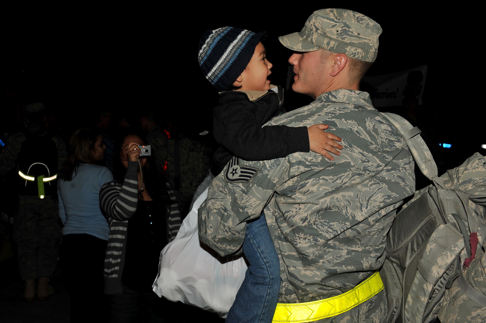 MOODY AIR FORCE BASE, Ga.-- Staff Sgt. Mark Graves, 23rd Aircraft Maintenance Squadron stock pile crew chief, holds his son, Caiden, in his arms after returning from a three-month deployment to Kandahar, Afghanistan, Dec 16. (U.S. Air Force photo/Airman 1st Class Joshua Green)(RELEASED)
