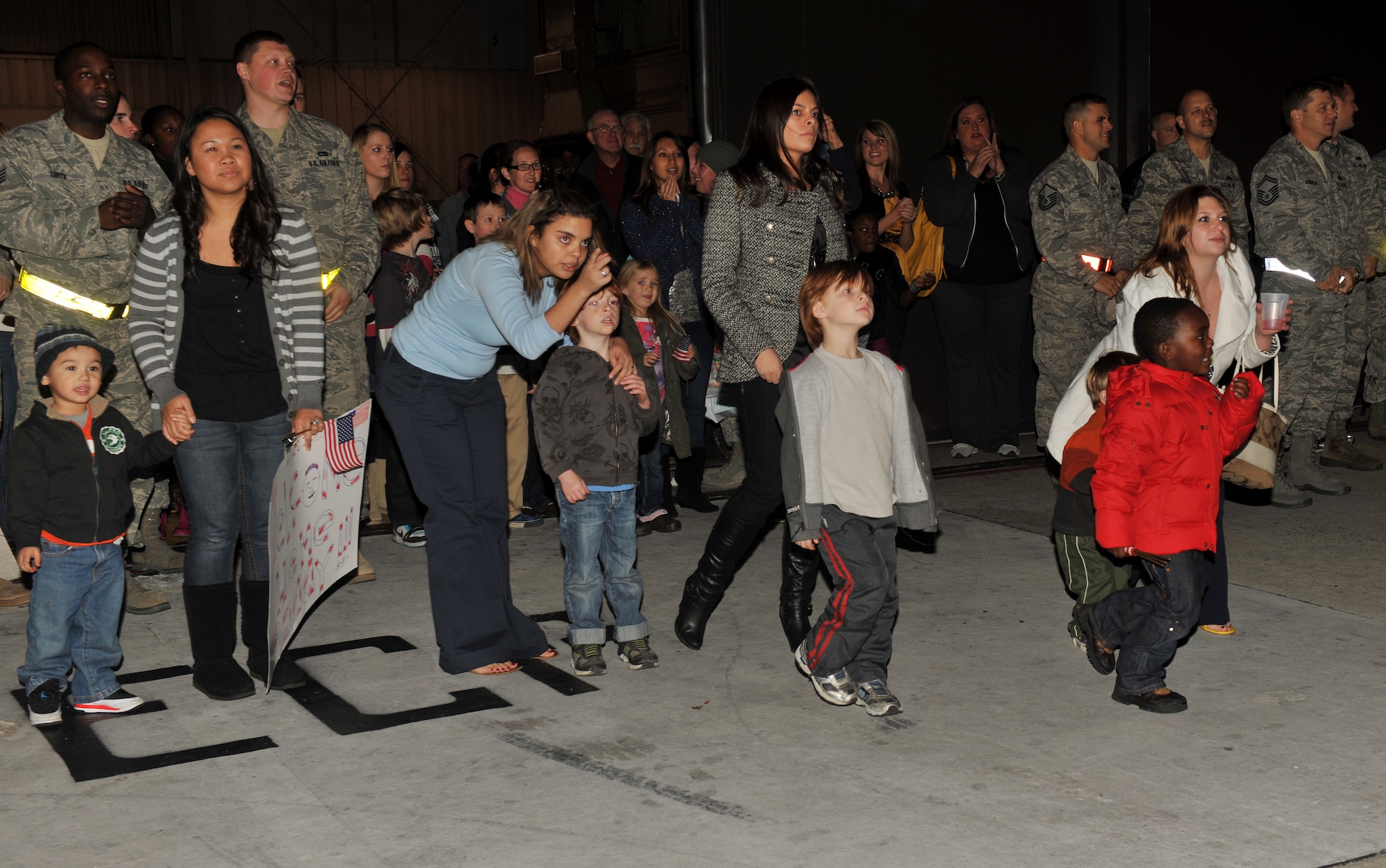 MOODY AIR FORCE BASE, Ga.-- Family members of the 23rd Aircraft Maintenance Squadron run toward their loved ones coming home from Kandahar, Afghanistan, Dec. 16. The squadron was deployed for three months. (U.S. Air Force photo/Airman 1st Class Joshua Green)(RELEASED)
