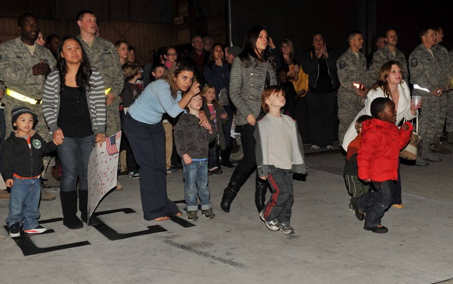 MOODY AIR FORCE BASE, Ga.-- Family members of the 23rd Aircraft Maintenance Squadron run toward their loved ones coming home from Kandahar, Afghanistan, Dec. 16. The squadron was deployed for three months. (U.S. Air Force photo/Airman 1st Class Joshua Green)(RELEASED)
