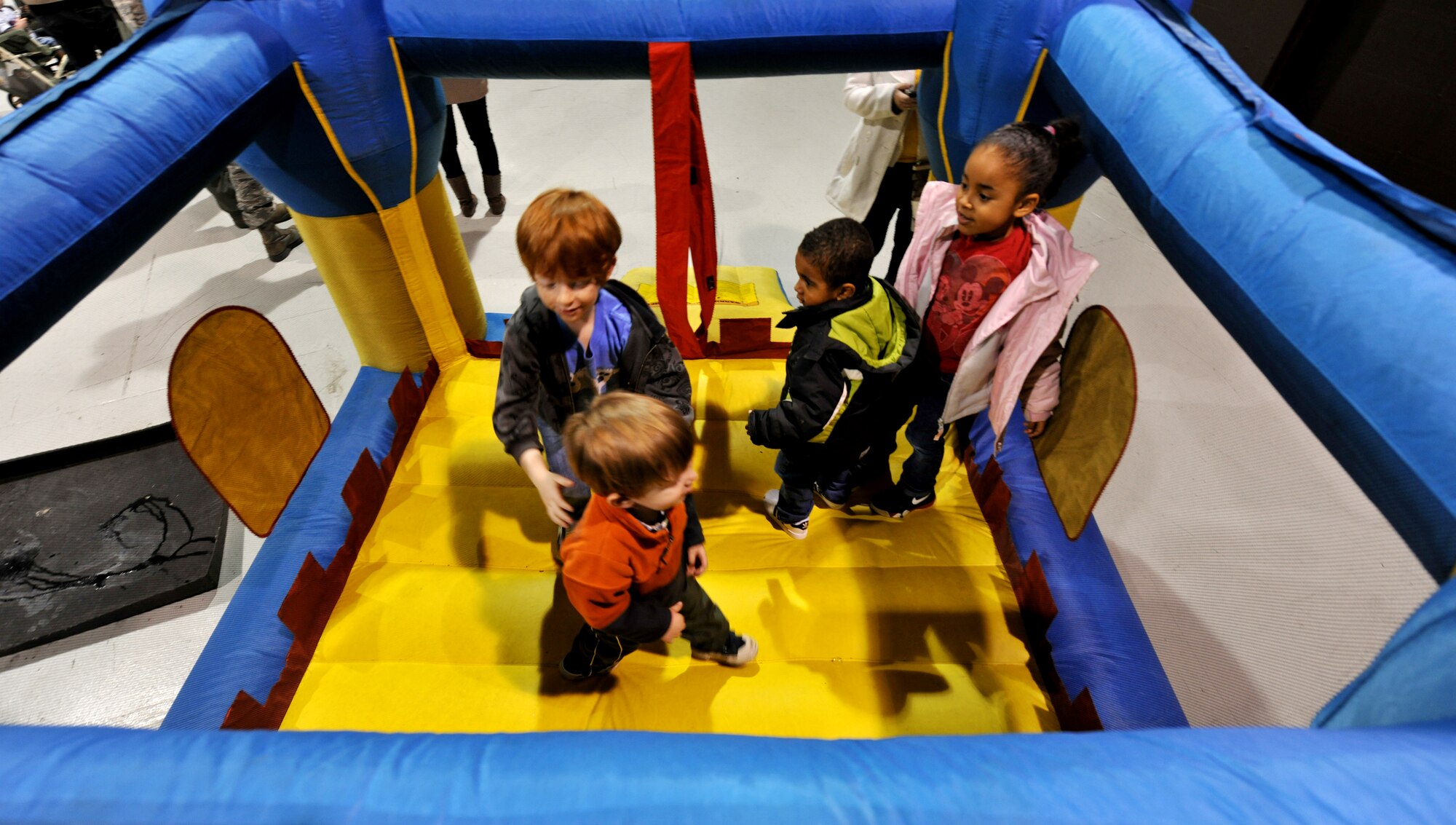 MOODY AIR FORCE BASE, Ga.-- Children play in a bounce house while they wait for their loved ones to return from a deployment Dec. 16. The Airmen from the 23rd Aircraft Maintenance Squadron were deployed to Kandahar, Afghanistan, for three months. (U.S. Air Force photo/Airman 1st Class Joshua Green)(RELEASED)
