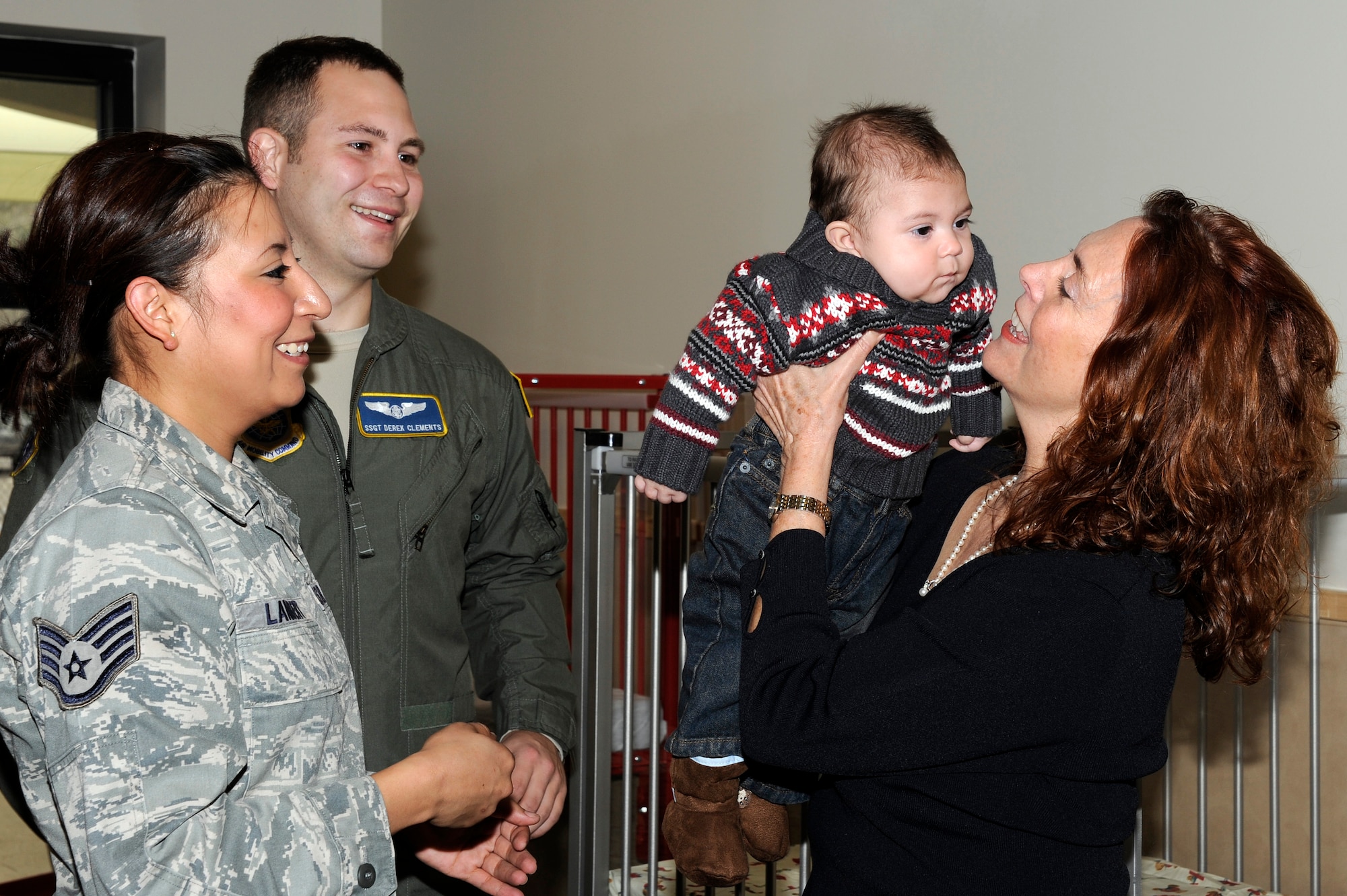 Mrs. Carmen Mikolajcik, right, welcomes Carson Clements and his parents, Staff Sgt. Rosa Lambert, left, and Staff Sgt. Derek Clements, back, to the new infant room at the new General Thomas R. Mikolajcik Child Development Center during the rededication ceremony at Joint Base Charleston on Dec. 16, 2010. Carson is the first infant to be accepted at the new center after waiting more than seven months for a spot to open up. The new center  is able to serve more than 300 children and replaced a 38-year-old facility that could handle about half as many children. Mrs. Phelps is the CDC director and Mrs. Mikolajcik is the wife of former General Mikolajcik. (U.S. Air Force photo/Staff Sgt. Marie Brown)