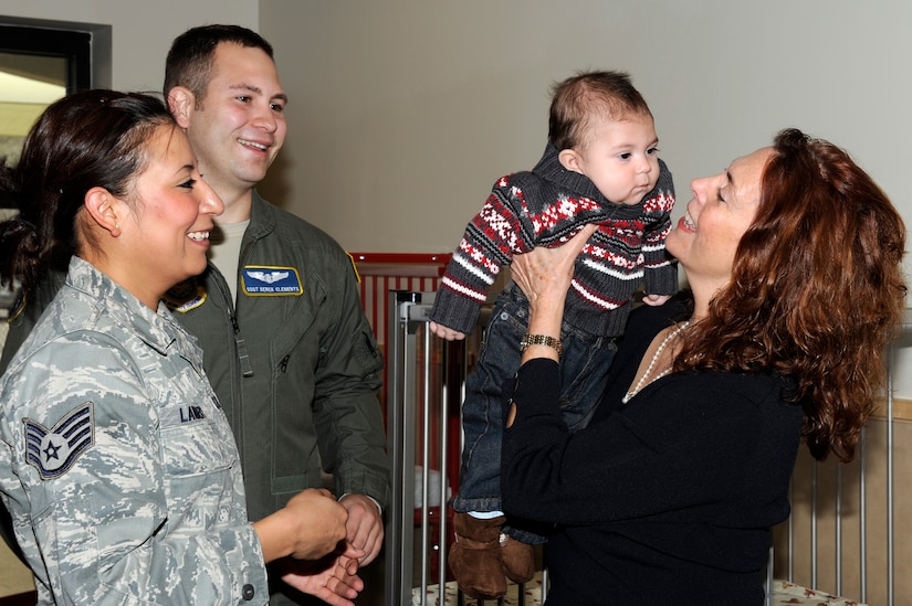 Mrs. Carmen Mikolajcik, right, welcomes Carson Clements and his parents, Staff Sgt. Rosa Lambert, left, and Staff Sgt. Derek Clements, back, to the new infant room at the new General Thomas R. Mikolajcik Child Development Center during the rededication ceremony at Joint Base Charleston on Dec. 16, 2010. Carson is the first infant to be accepted at the new center after waiting more than seven months for a spot to open up. The new center  is able to serve more than 300 children and replaced a 38-year-old facility that could handle about half as many children. Mrs. Phelps is the CDC director and Mrs. Mikolajcik is the wife of former General Mikolajcik. (U.S. Air Force photo/Staff Sgt. Marie Brown)