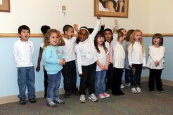 Children of the new General Thomas R. Mikolajcik Child Development Center sing "We're so happy" during the rededication ceremony at Joint Base Charleston on Dec. 16, 2010. The new center  is able to serve more than 300 youngsters and replaces a 38-year-old facility that could handle about half as many children. (U.S. Air Force photo/Staff Sgt. Marie Brown)