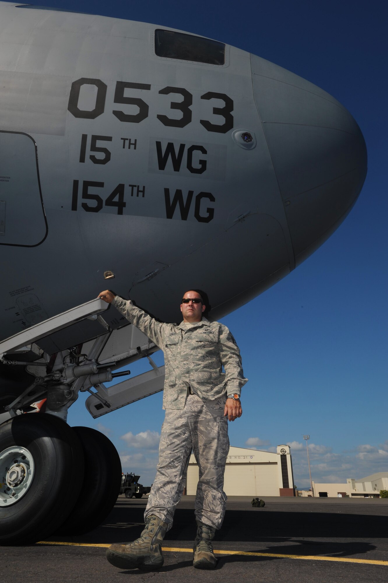 Tech. Sgt. Dwayne Seagle, 15th Aircraft Maintenance Squadron electrician, stands with Tail 0533, a C-17 Globemaster III that was grounded for 45 days due to a major discrepancy at Joint Base Pearl Harbor-Hickam, Hawaii, Dec. 16. Sergeant Seagle led the "Tiger team," a team assembled with the sole focus of getting Tail 0533, a plane 15 years older than every other 15th Wing C-17, back in the air. (U.S. Air Force Photo/Airman 1st Class Lauren Main)