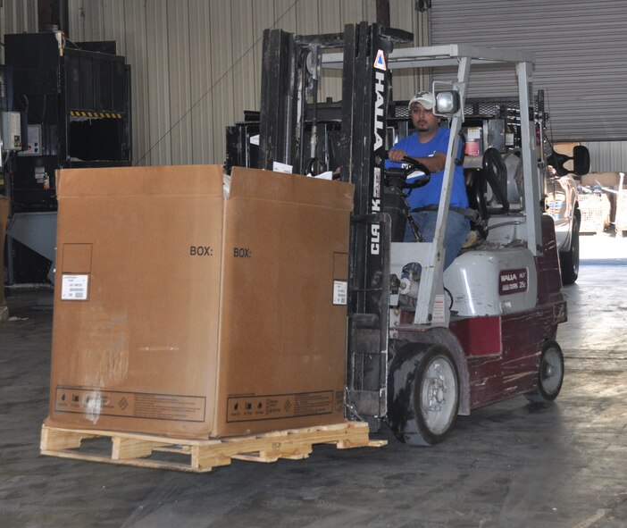 LAUGHLIN AIR FORCE BASE, Texas—George Ramirez, a Laughlin recycling center associate, drives a fork lift with a box of outdated flight manuals and publications. The documents are loaded onto a truck and driven to San Antonio where they can be processed. (U.S. Air Force photo by 2nd. Lt. Angela Martin)