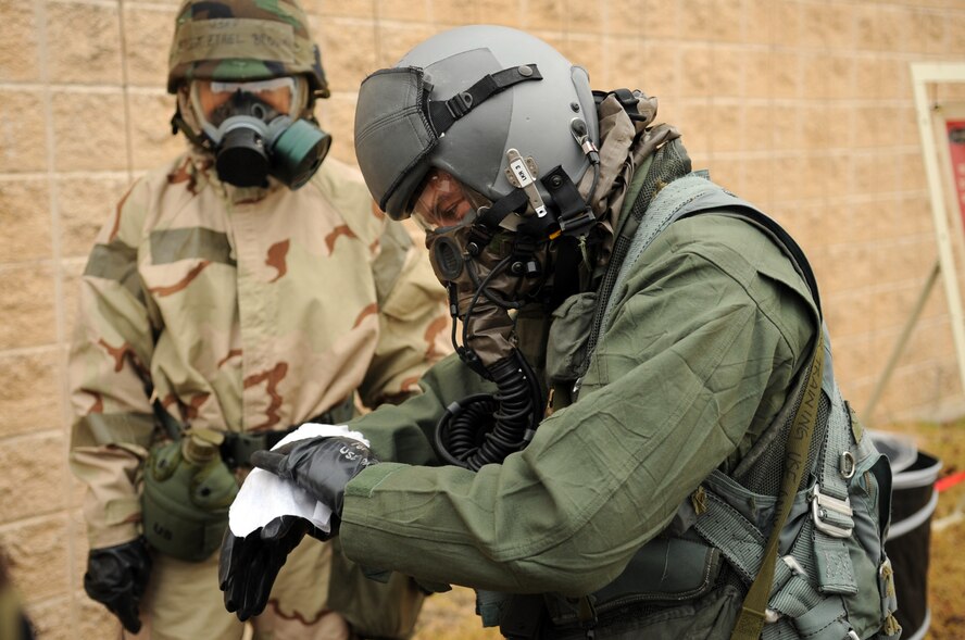 MOODY AIR FORCE BASE, Ga. -- -- Maj. Bryan Nickola, 23rd Fighter Group A-10C Thunderbolt II pilot, cleans his gloves Dec. 17. Major Nickola was part of a decontamination training course and cleaned his gloves to prevent the spread of contamination. (U.S. Air Force photo/Airman 1st Class Douglas Ellis)(RELEASED)