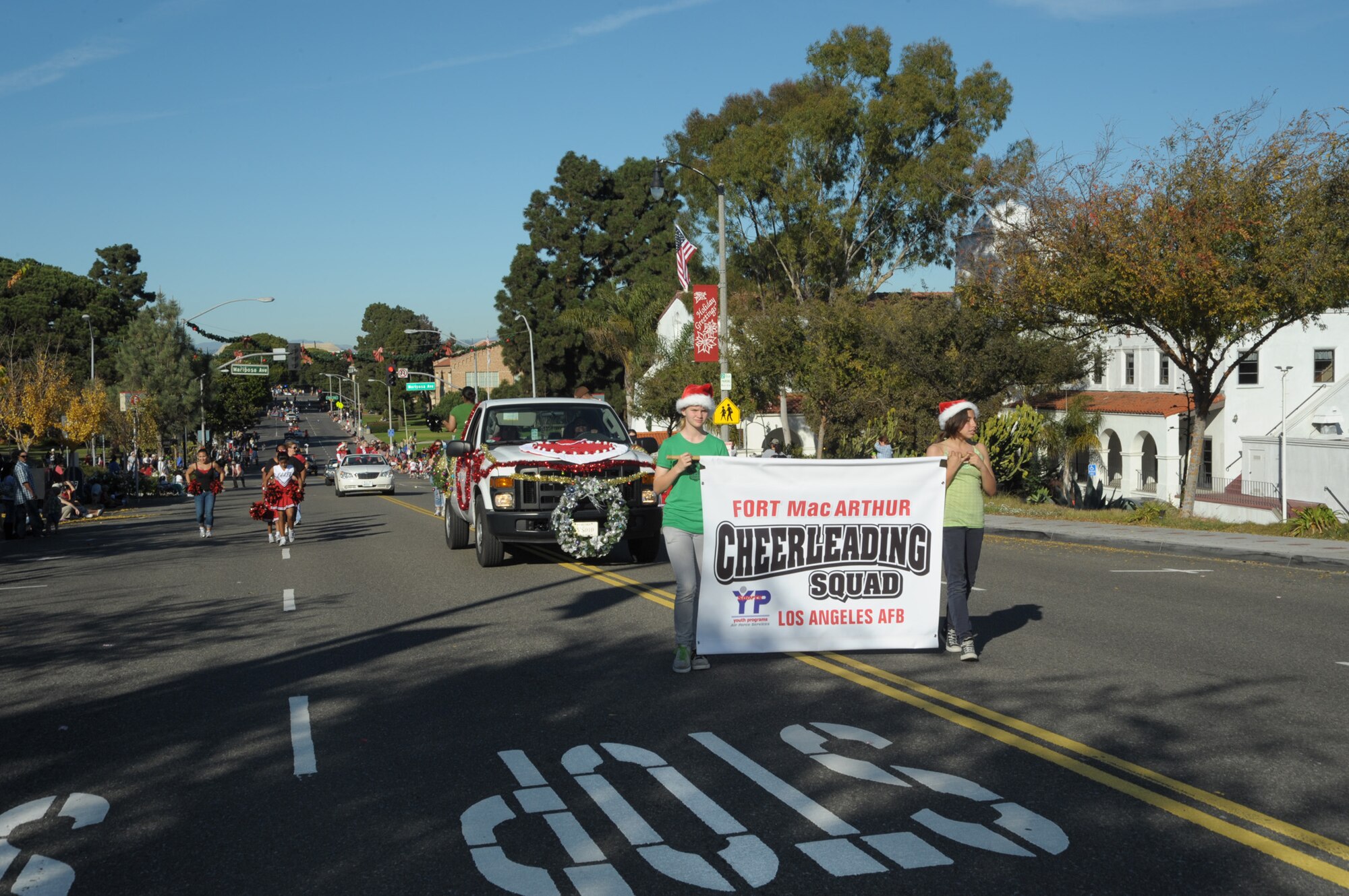 Cheerleaders from LAAFB’s Youth Services program march in the City of El Segundo’s annual holiday parade, Dec. 12. (Photo by Joe Juarez)