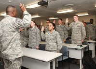 Chief Master Sgt. Juan Lewis, 502nd Air Base Wing command chief, leads Airmen at the First Term Airmen Center in a pledge to achieve five goals by the end of their first enlistment Dec. 15. FTAC helps Airmen transition from a training environment to their first duty station. (U.S. Air Force photo/Robbin Cresswell)