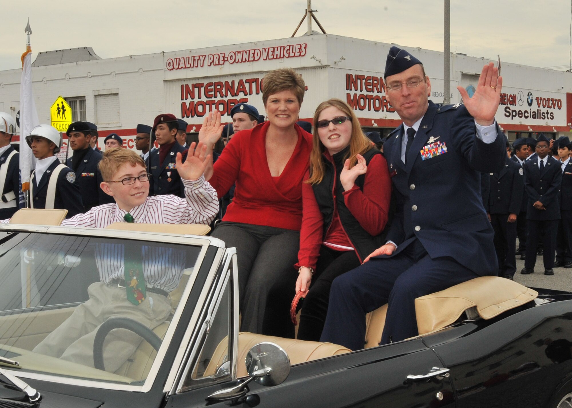 Colonel Frank Simcox, 61st Air Base Group commander, his wife, Susan and children, Caitlin and Frank rode in a vintage car in the San Pedro Holiday Parade, Dec. 6. (Photo by Lou Hernandez)