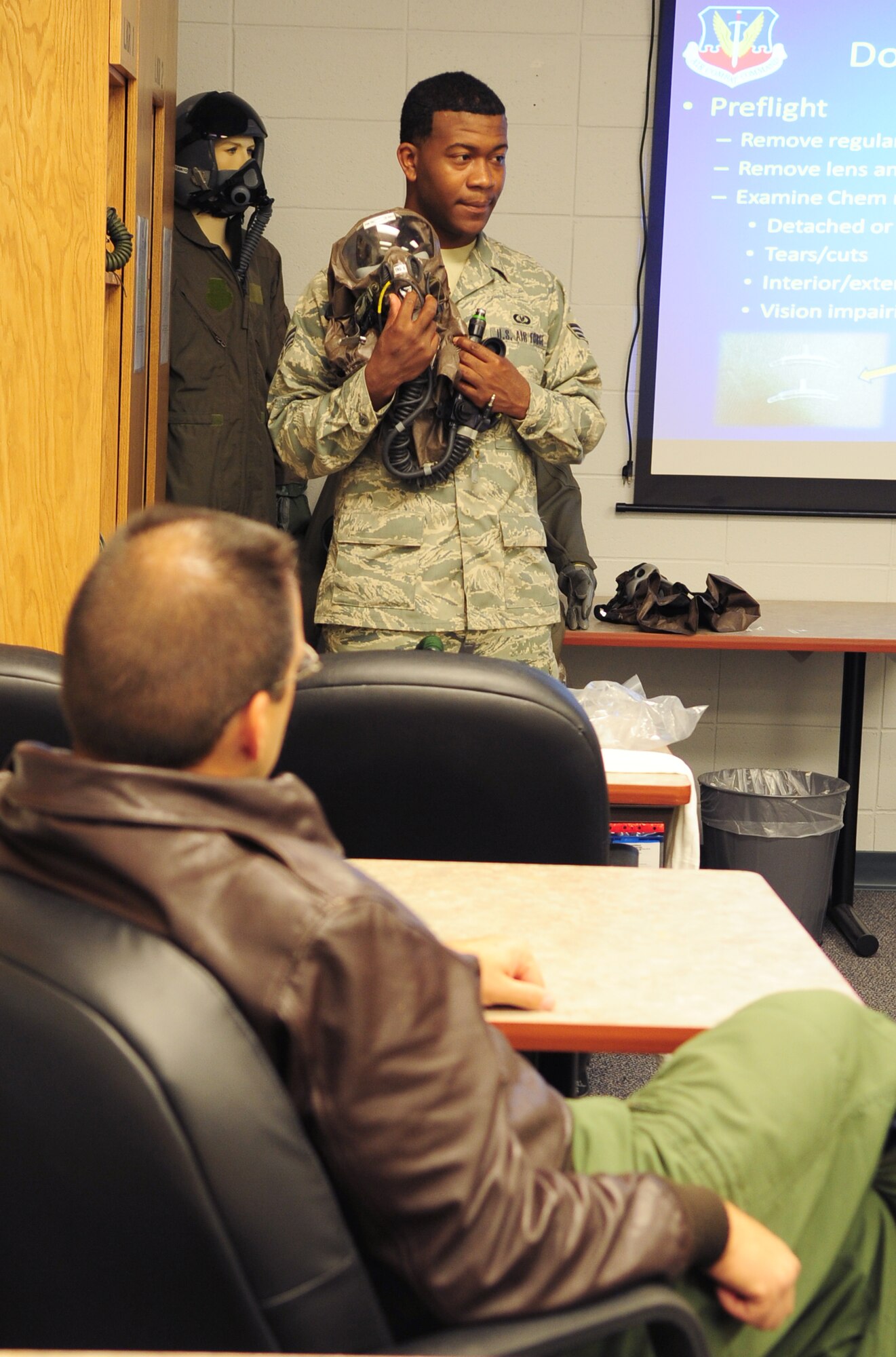 MOODY AIR FORCE BASE, Ga. -- Senior Airman Willie Mason, 23rd Operations Support Squadron aircrew flight equipment technician, teaches the proper way to wear chemical warfare gear Dec. 17. The class is an annual requirement for pilots. (U.S. Air Force photo/Senior Airman Stephanie Mancha)(RELEASED)
