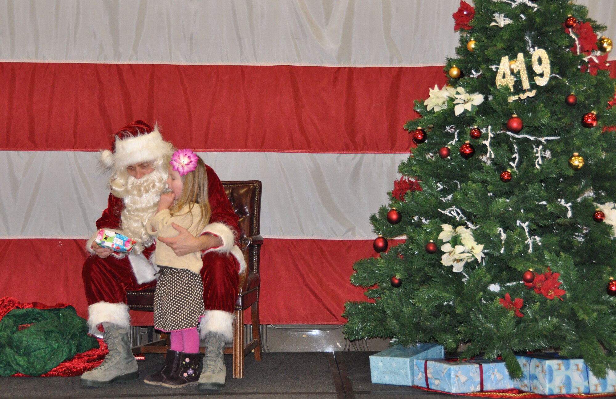 Madilyn Cocanour, age 3, takes some time to think about her Christmas wish list before sharing it with Santa during the 419th FW’s annual Christmas party Dec. 16. Madilyn’s father, Tech. Sgt. Paul Cocanour, is assigned to the wing’s Aircraft Maintenance Squadron. (U.S. Air Force photo/Kari Tilton)