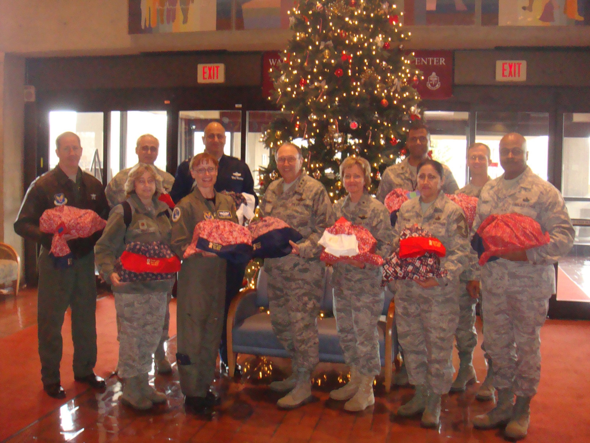 Airmen from the Office of Air Force Reserve form up in the Walter Reed Hospital Reception area to present care packages to Wounded Warriors Dec. 3, 2010. In the front row from left are Maj. Cathy Hight, Medical Directorate; Maj. Dee Ketterer, chief of Reserve Mobility Programming; Lt. Gen. Charles E. Stenner Jr., chief of Air Force Reserve; Brig. Gen. Maryanne Miller, director of Programs and Requirements; Chief Master Sgt. Beatriz Swann, Personnel Directorate; and Senior Master Sgt. Curtis Webber, Programs and Requirements Directorate. In the back row from left are Col. Mark Ross, Policy Integration Directorate; Col. Mike Ricci, Programs and Requirements Directorate; Brig. Gen.  Richard Haddad, special assistant to the chief of Air Force Reserve; Maj. Gary Byrd, Programs and Requirements Directorate; and Col. Hugh Hegtvedt, executive officer to the chief of Air Force Reserve. (U.S. Air Force photo/Col. Bob Thompson)                             