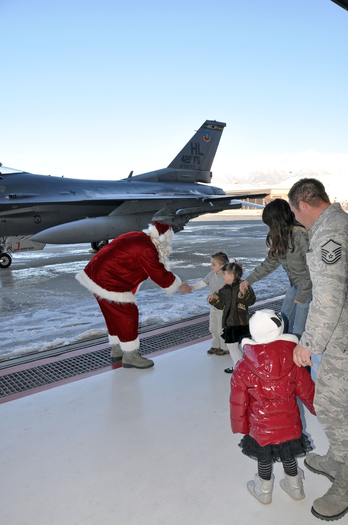 Santa greets several children upon his arrival at the 419th FW’s annual Christmas party Dec. 16. (U.S. Air Force photo/Kari Tilton)