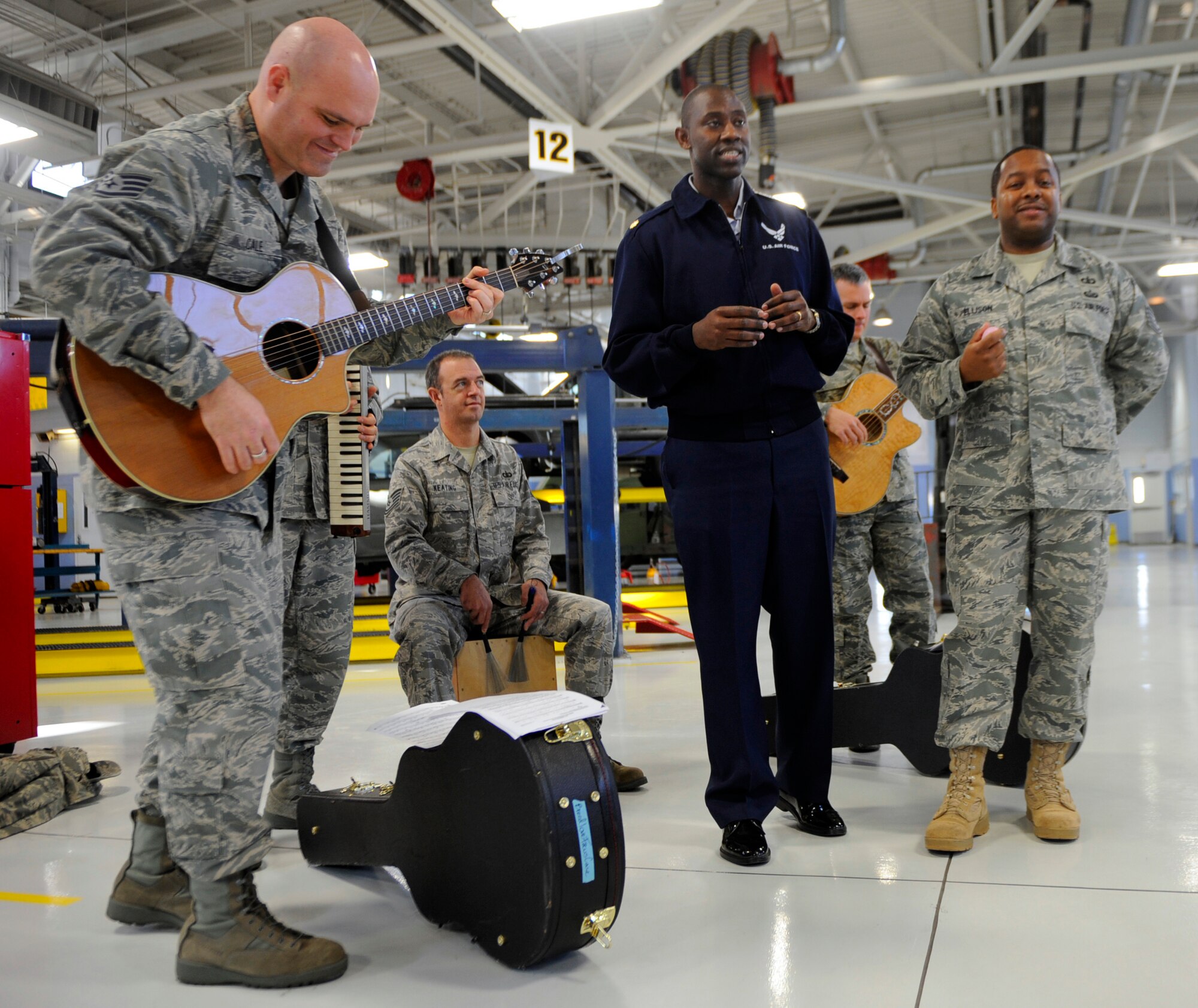MOUNTAIN HOME AIR FORCE BASE, Idaho -- Maj. Jamaal Mays, 366th Logistics Readiness Squadron commander, sings a song with the Air Force Band of the Golden West as they perform for LRS staff members Dec. 16. The band traveled from Travis AFB, Calif., to perform Christmas songs throughout the wing. (U.S. Air Force photo by Senior Airman Renishia Richardson)