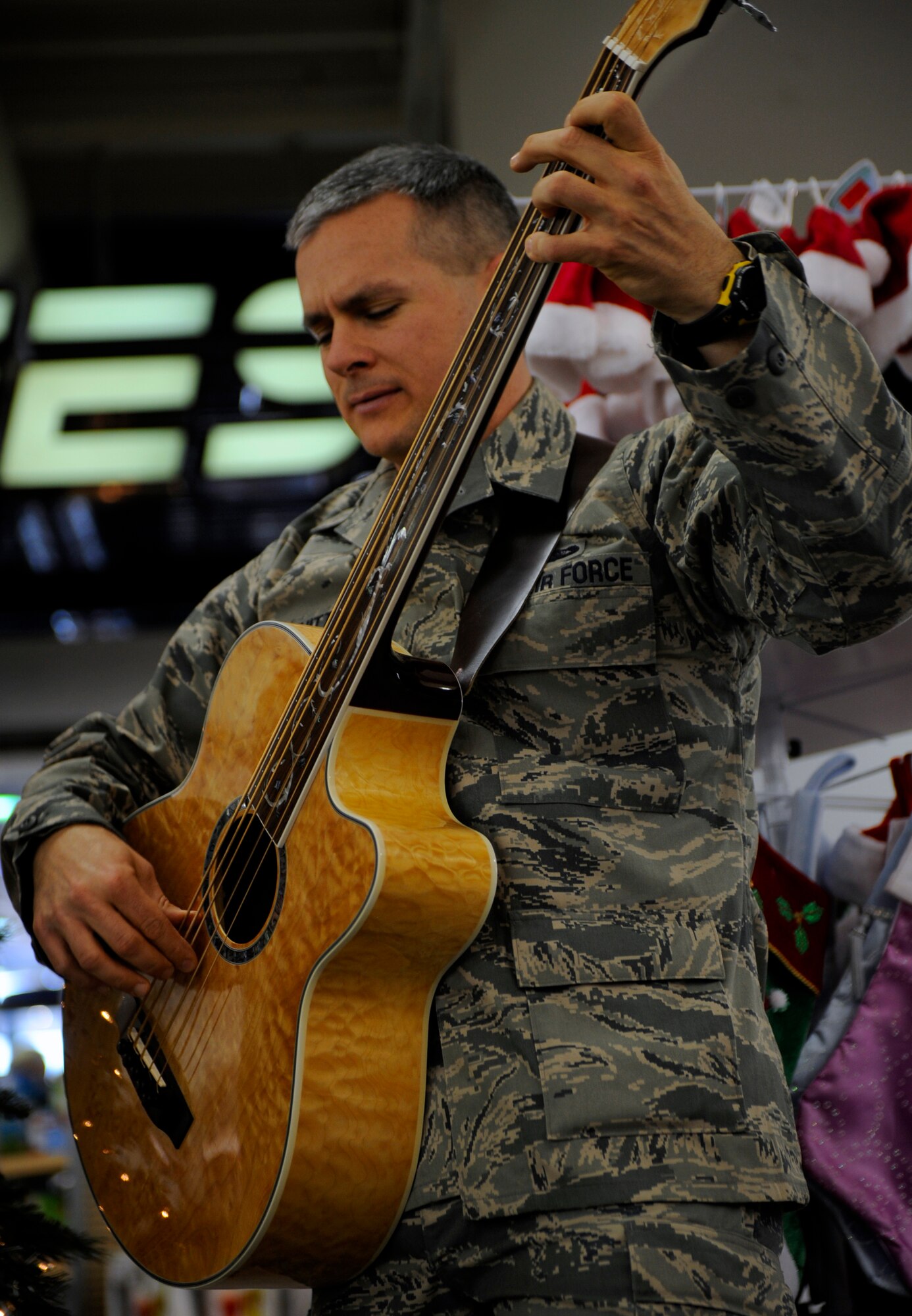 MOUNTAIN HOME AIR FORCE BASE, Idaho -- Airman 1st Class Joseph Whitt, Air Force Band of the Golden West bass player, enjoys a song while performing at the base exchange Dec. 16. The band traveled from Travis AFB, Calif., to perform Christmas songs throughout the wing. (U.S. Air Force photo by Senior Airman Renishia Richardson)