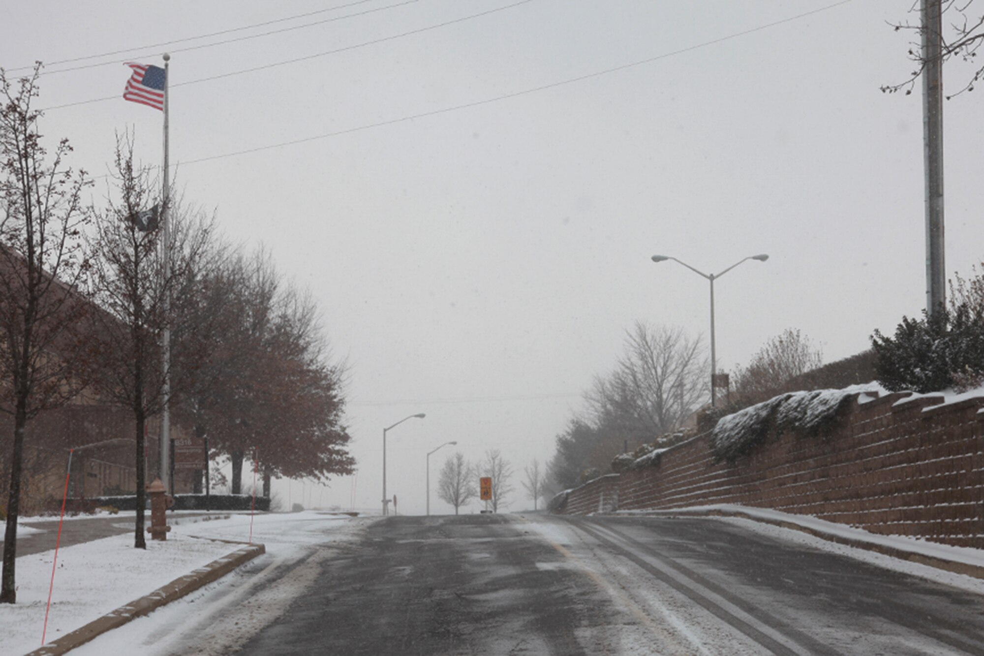 Extreme caution is advised while travelling on and off base, Dec. 13.
Weather conditions begin to worsen during the daytime, as seen in here on
Defense Avenue.  The cold, snow and high winds keep most personnel indoors
and off the streets.
