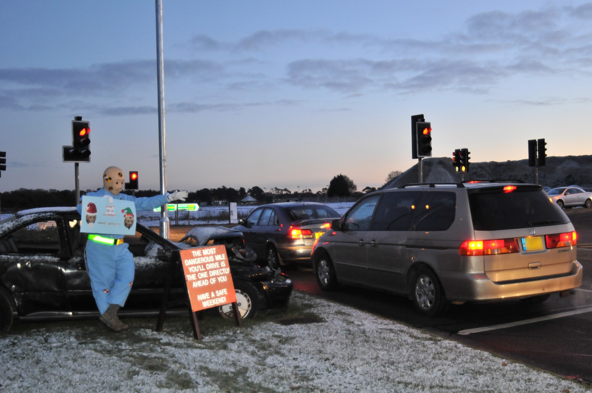 ROYAL AIR FORCE LAKENHEATH, England – Larry the Crash Dummy reminds departing Lakenheath motorists to be careful Dec. 17 at the Lakenheath main gate. The 48th FW Safety Office encourages all drivers to practice safe driving habits this holiday season. (U.S. Air Force photo/Senior Airman David Dobrydney)