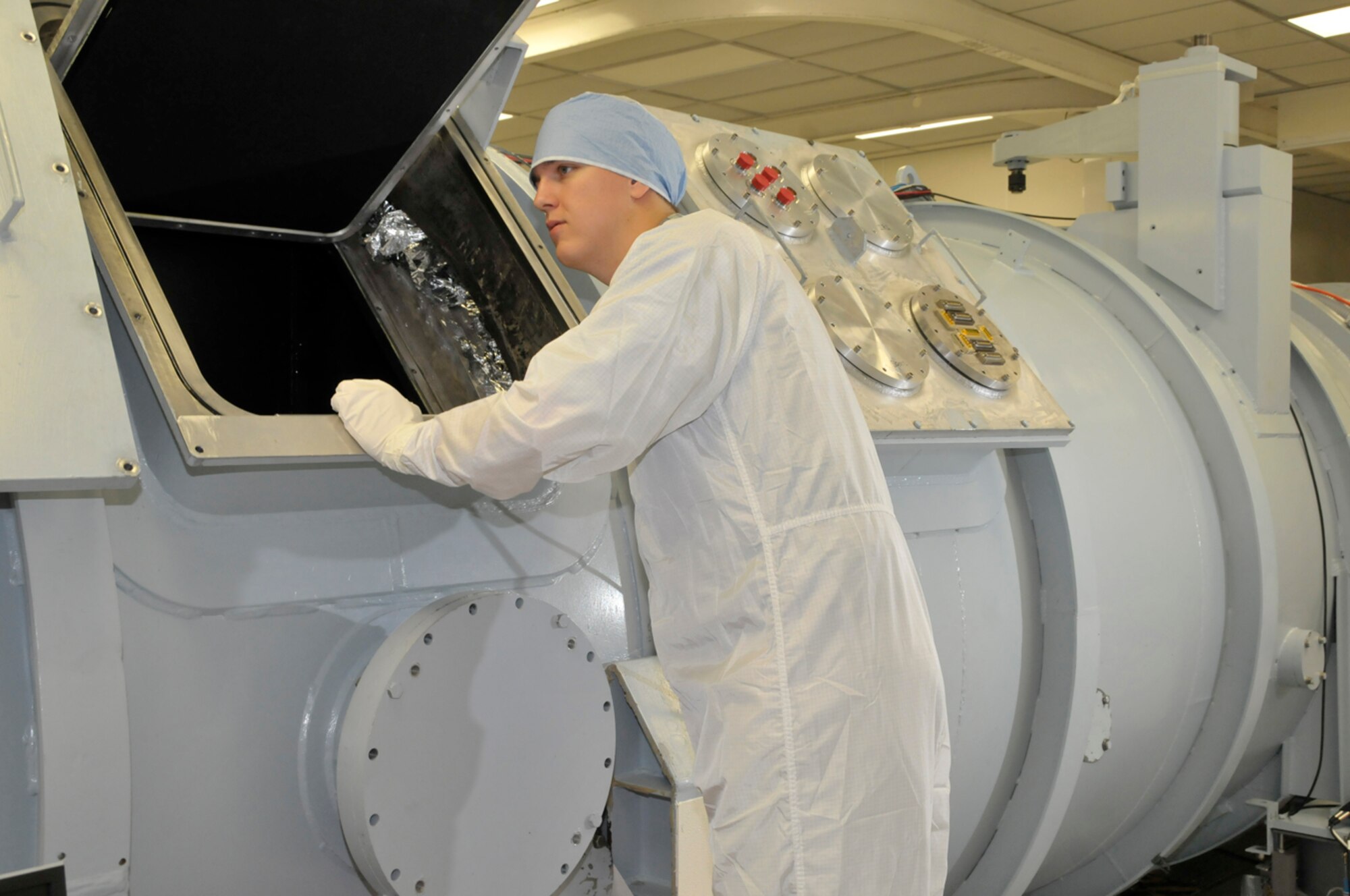 John Claybrook, AEDC’s most recent PALACE Acquire program employee, peers into the antechamber of the 7V Space Chamber. The antechamber is used to test the sensor under simulated flight altitude conditions while then the sensor looks into the space background (looking into the regular 7V Chamber).  (Photo by Rick Goodfriend)