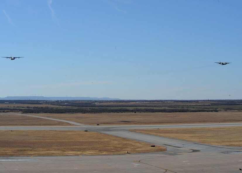 DYESS AIR FORCE BASE, Texas – A C-130 Hercules and a C-130J fly over Dyess Air Force Base Dec. 16 in the first formation flight the two aircraft have flown in formation here. Dyess is replacing the current aging fleet of C-130H models with 28 C-130J models by 2013. The C-130Hs are being sent to different bases or being retired. The aircraft brings many improvements over the C-130H model including avionics and an enhanced cargo handling system. (U.S. Air Force Photo by/ Airman 1st Class Chelsea Cummings)