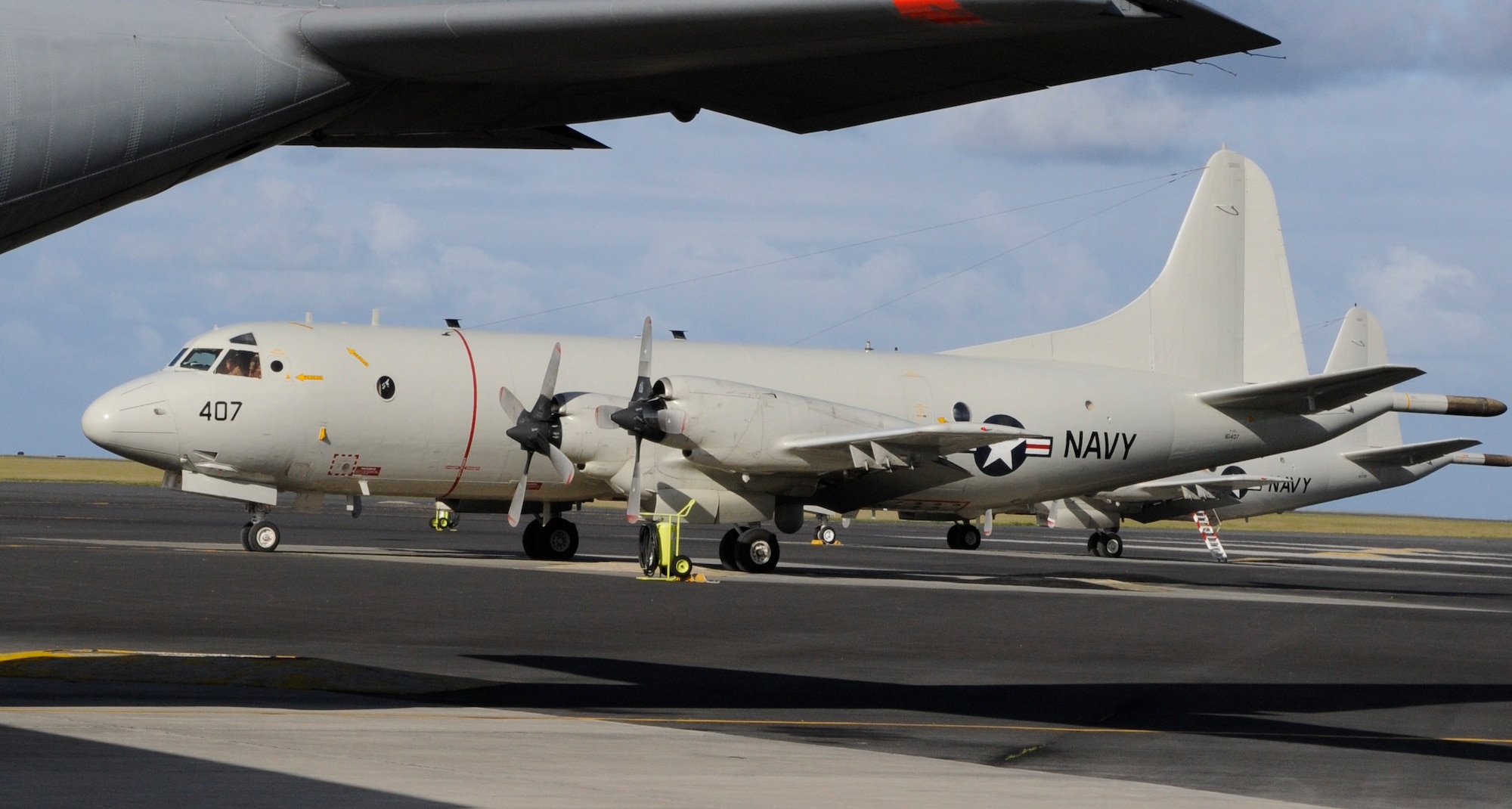 Two P-3 Orions from the 46th Patrol and Reconnaissance Squadron land at Lajes Field to refuel before returning home after a deployment in support of Operation Iraqi Freedom Dec. 6, 2010.  More than five P-3s from the 46th Patrol and Reconnaissance Squadron have landed here this month.  (Photo by Tech. Sgt. Chyrece Campbell)