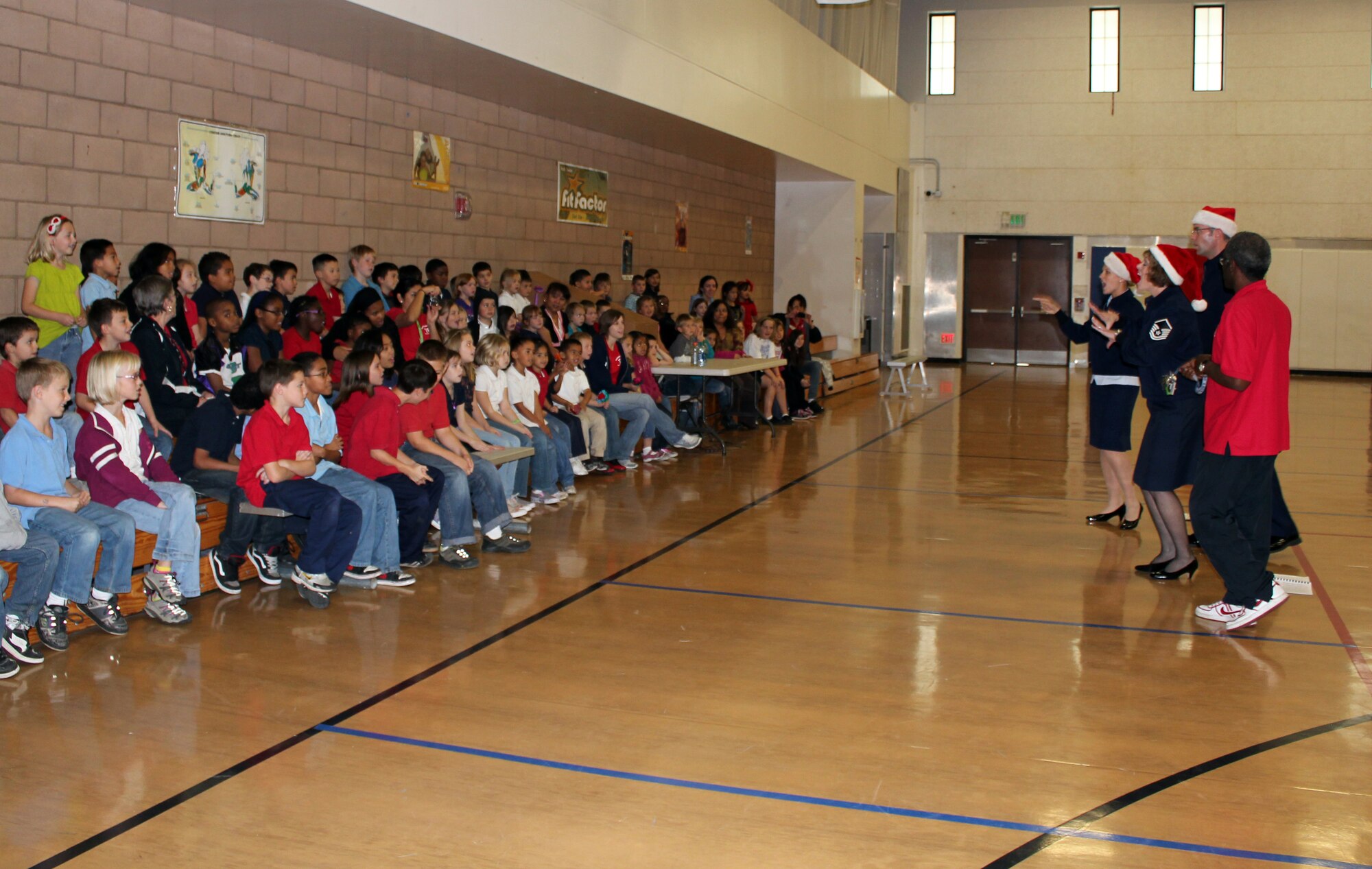VANDENBERG AIR FORCE BASE, Calif. – Airman 1st Class Megan Hokaj, Staff Sgt. Geoffrey Fisher, and Master Sgt. Amy Lukens-Malone, from the Band of the Golden West based out of Travis Air Force Base, sing Christmas carols at the Vandenberg Youth Center here Wednesday, Dec. 15. 2010.  The band also traveled around base to spread holiday cheer to the Vandenberg community this season. (U.S. Air Force Photo/Jennifer Green)