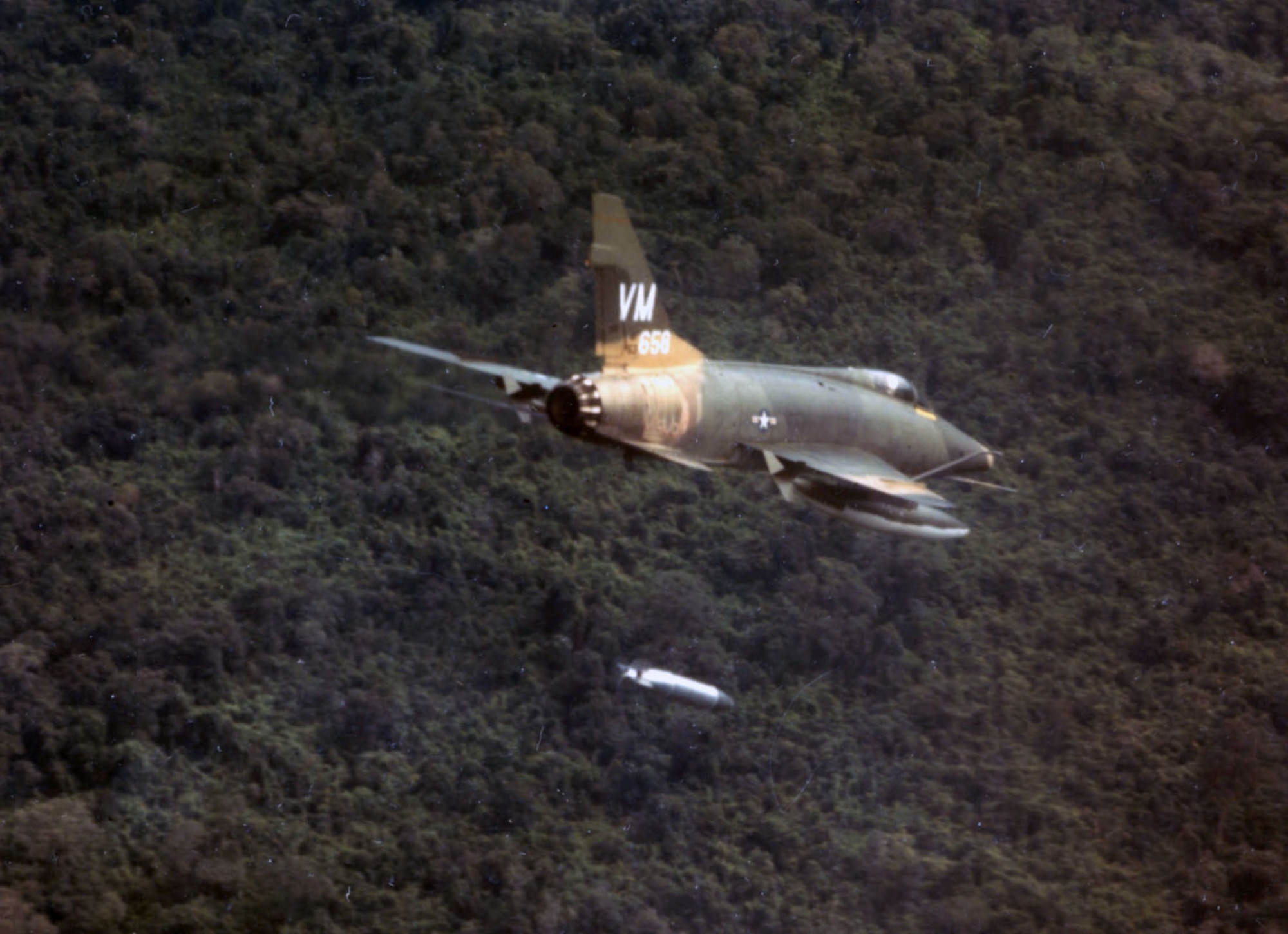 F-100D of the 352nd Tactical Fighter Squadron dropping a napalm bomb near Bien Hoa, South Vietnam. Super Sabres could carry an impressive array of weapons, including high explosive bombs, napalm, rockets, cluster bombs and even the guided Bullpup missile. (U.S. Air Force photo)