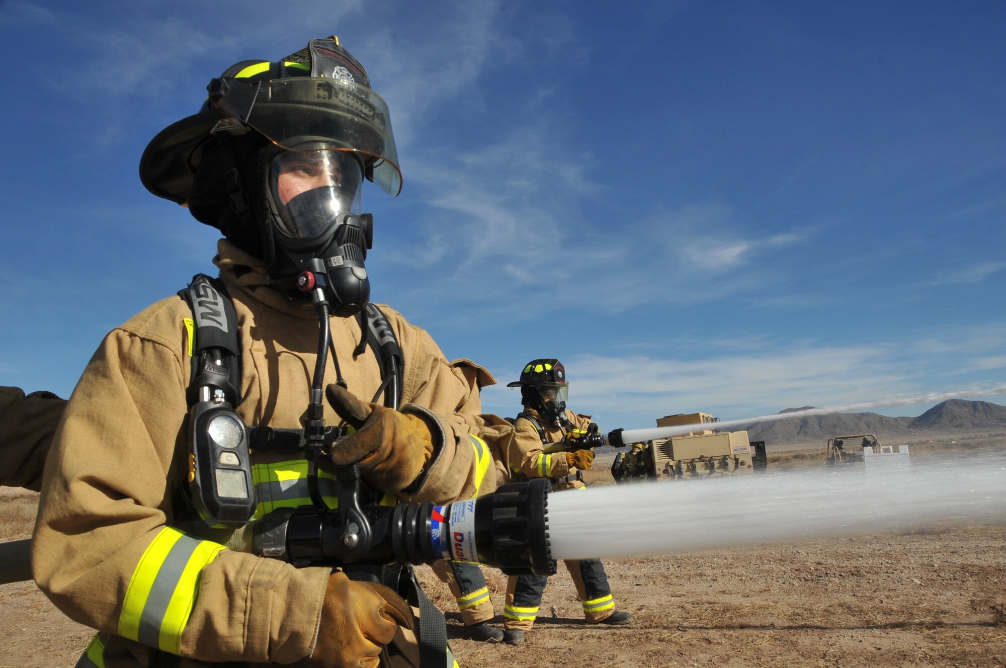 Firefighters from Kirtland Air Force Base use hoses to put out a fire during a recent exercise. U.S. Air Force Photo by Todd Berenger.