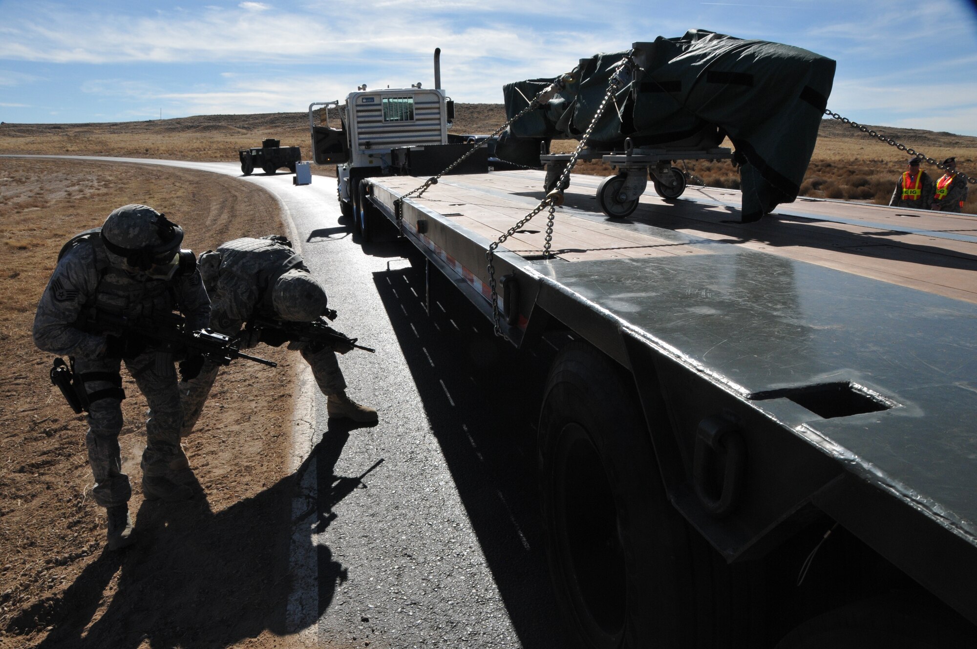 Two airmen check beneath a semi during the exercise. U.S. Air Force Photo by Ken Moore.